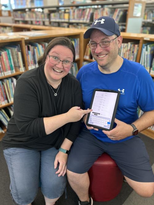 two people with a tablet.