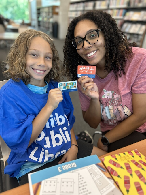 Two People with library card.