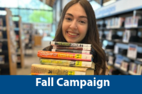 Teenager holding a stack of books